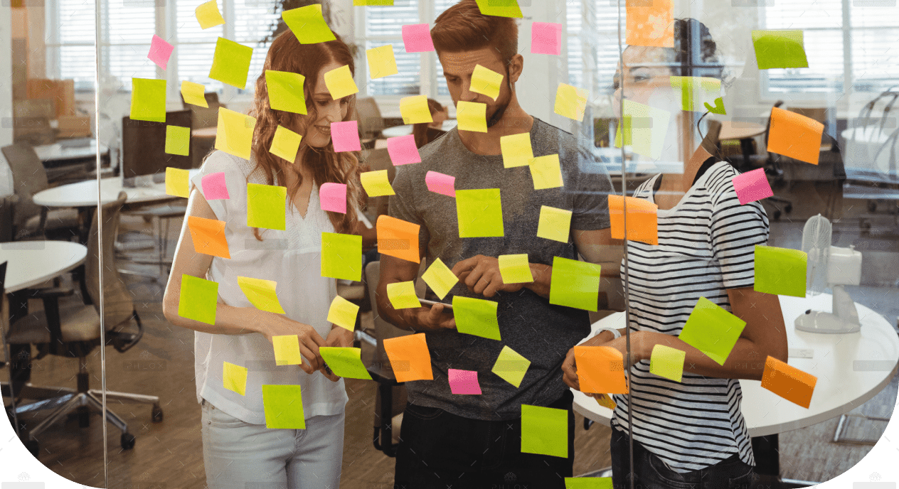 demo-attachment-1495-business-executives-standing-near-glass-with-sticky-notes-di-1-1